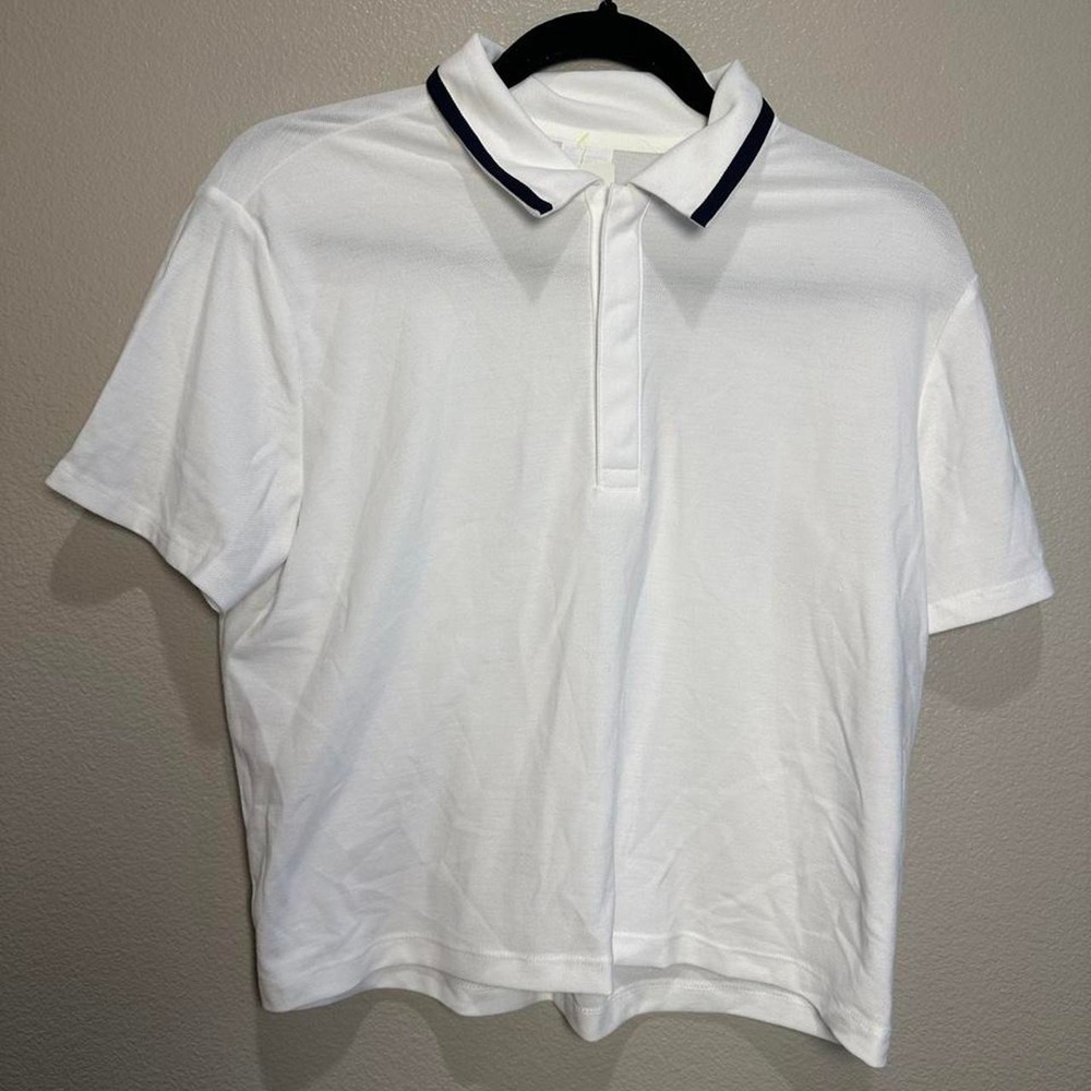 White polo shirt with navy blue collar trim, size S. Cropped Length